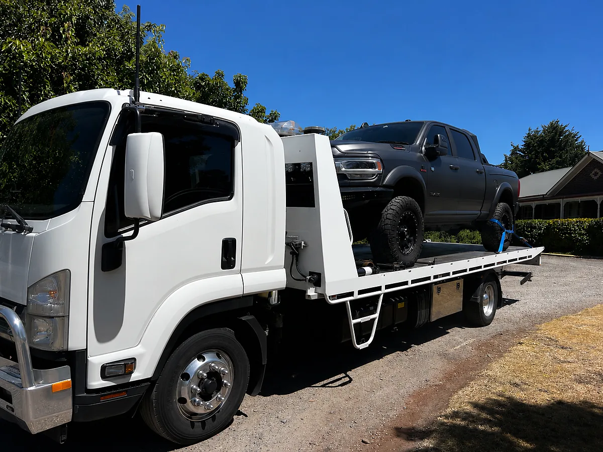 RKP Towing flatbed tow truck carrying a ute - 24/7 emergency towing near Romsey and western Melbourne